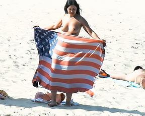 Holding an American Flag Towel on a Topless Beach