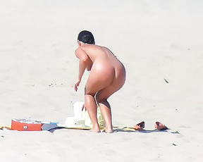 Sandy Nudist Beach Spot with Towel, Sandals and Bucket