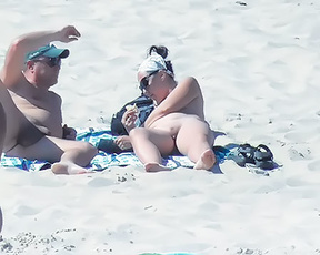 Nude Beach Couple Resting on a Patterned Towel