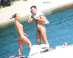 Nudist Beach Couple Beside the Calm Blue Water