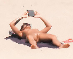 Scorching Beach Weekend — Nude Sunbather Lost in Her Phone