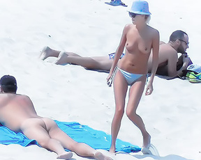 Topless Beach Moment Beside Sunbathers on Light Sand