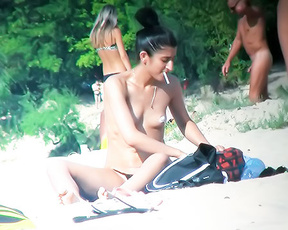 Sorting Beach Gear Topless on a Sandy Towel
