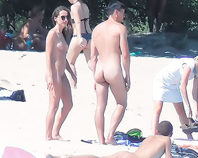 Five Naturists Gathered on a Bright Sandy Beach