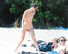 Three Nudists Sharing Towels on a Nude Beach