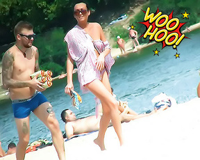 Walking Past Sunbathers on a Naturist Riverbank