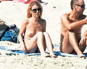 Two Nudists Sharing a Towel on Sandy Shore 1