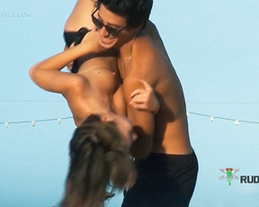 Topless Beach Couple Near Hanging String Lights