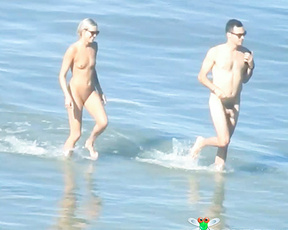 Nude Beach Couple Stepping Through Shallow Waves
