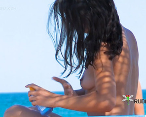 Woman Applying Sunscreen by the Pool