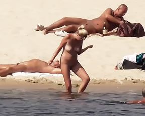 Naked lady naturist lets the water kiss her body