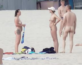 Naughty youthful naturists play with each other in sand