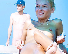 Two Nudists Sharing a Sunlit Moment on the Sand