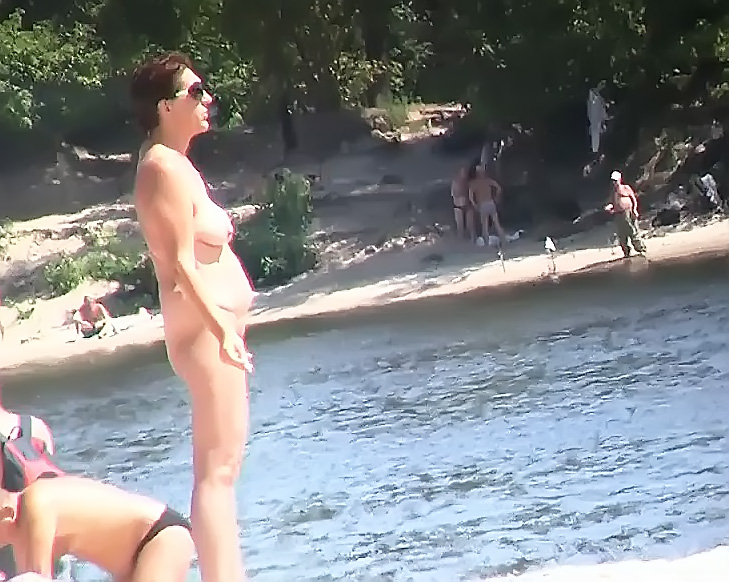 Slim girl with perky boobs naked at a nudist beach 2