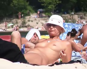 Two skinny naturist girls frolic around the strand 3