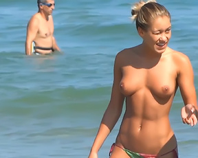 Young nudist babes secretly filmed by a voyeur having fun at the topless beach