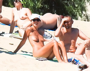 Playful, young nudist chick caught on a voyeur camera having fun at the beach