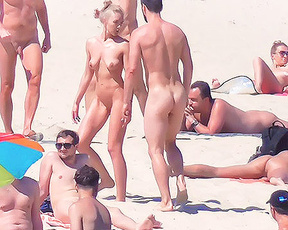 Skinny nude beach girl filmed on a video by a voyeur.