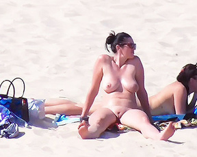 My wife getting her beautiful breasts and hard nipples tanned on the plage.
