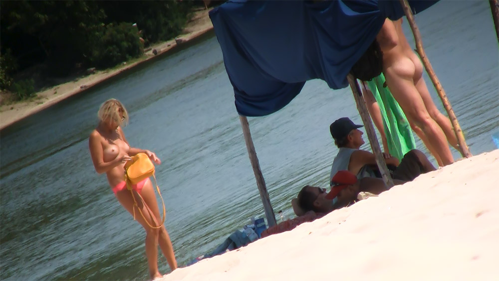 Dazzling blonde enjoys a sunny day by the river naked