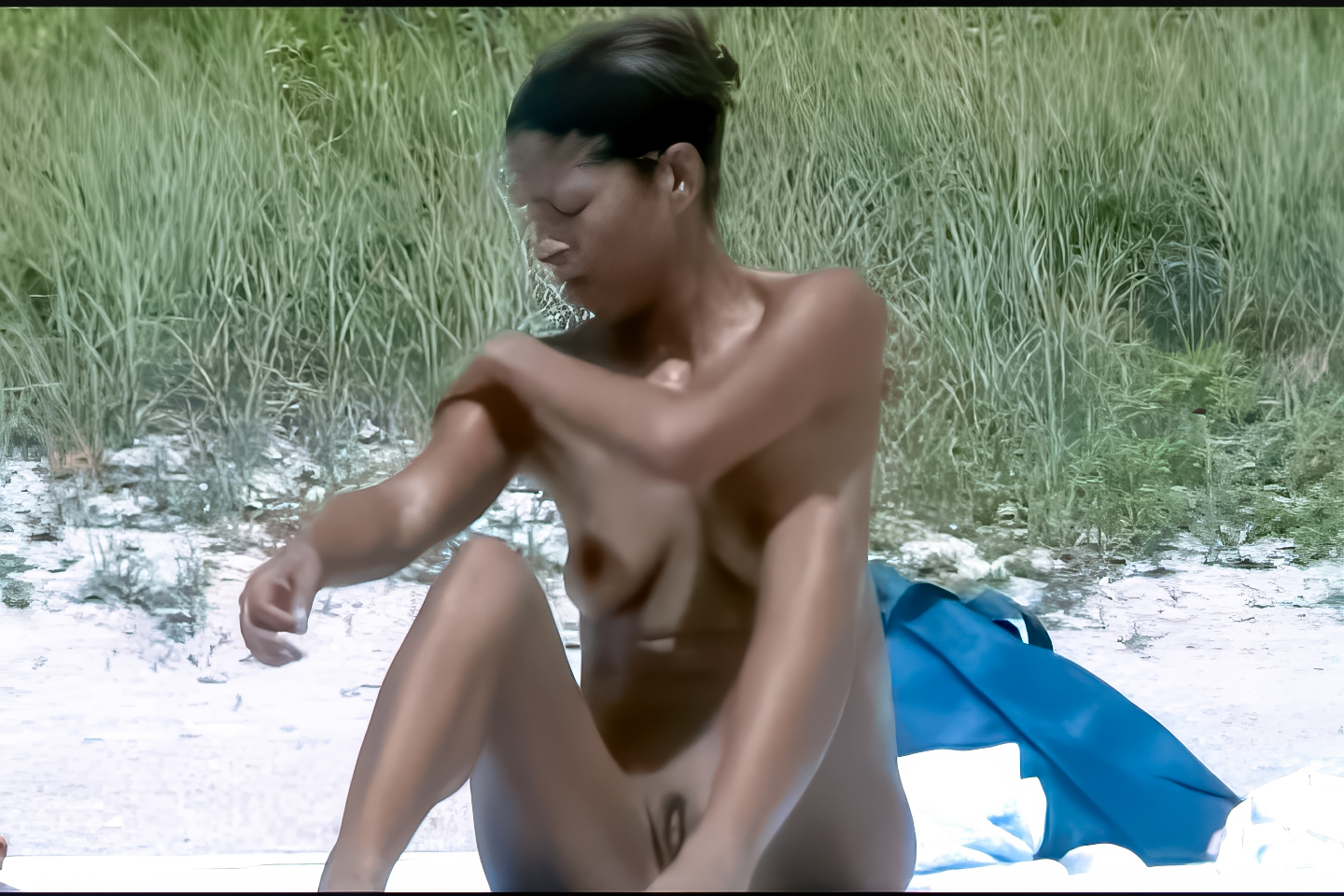 Sitting on the Sand at a Nude Beach Beside Tall Grass