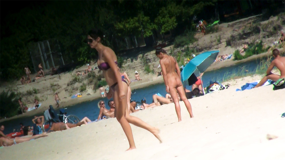 Blue Umbrella on a Quiet Riverside Nudist Beach