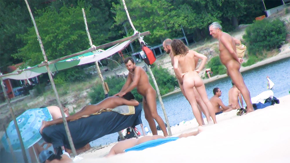 Five Naturists Standing Together at a Poolside Edge