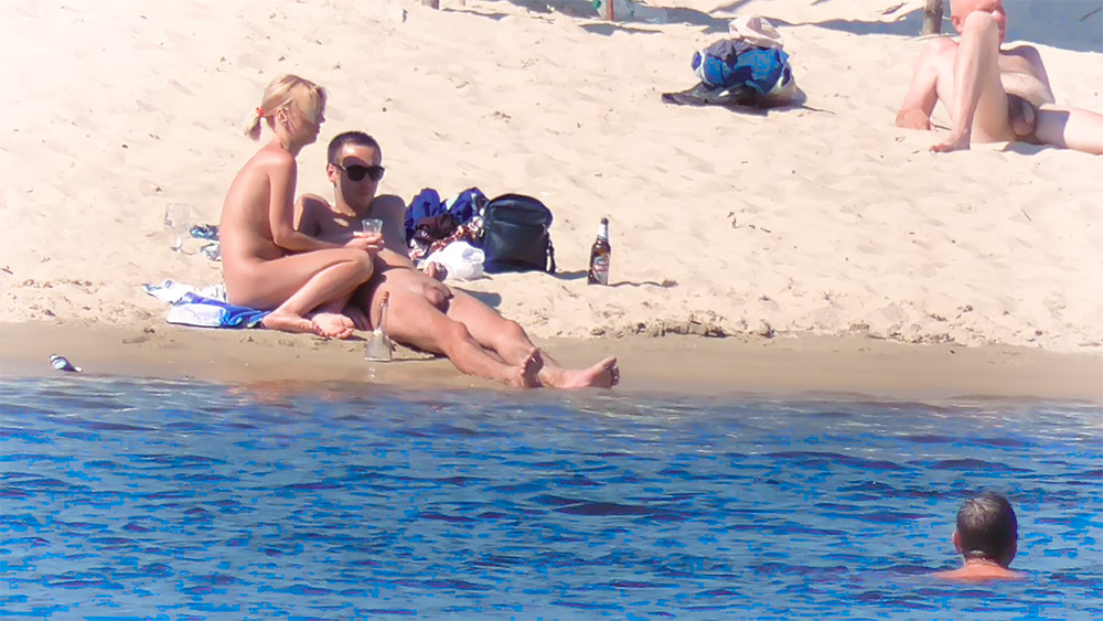 Nude Beach Couple Resting Together by Calm Water