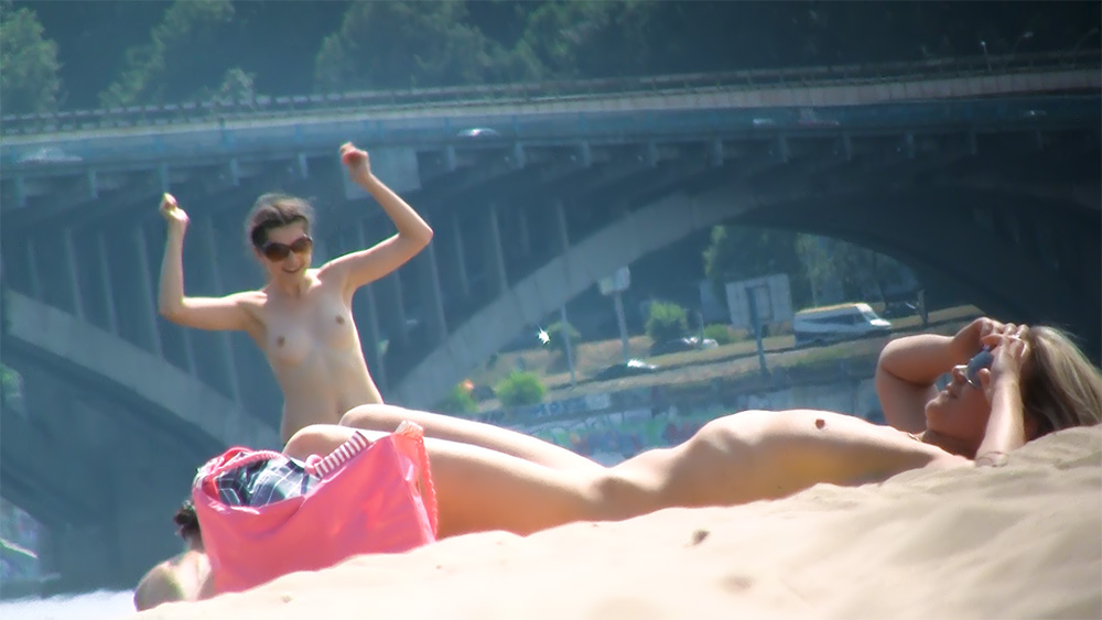 Topless Beach Sunbather Beside a Red Tote Bag