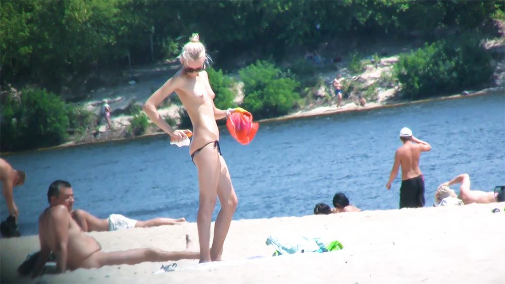 This beautiful babe was nude in the beach with some older -- and bigger -- woman friend.