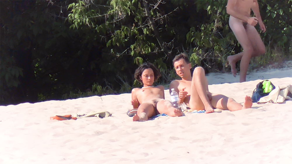 Nude Beach Couple Resting on Open Sand