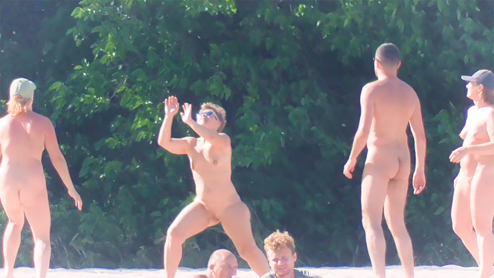 Four Naturists Catching a Ball at an Outdoor Clearing