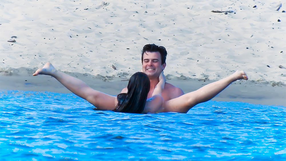Couple Playing in a Pool Beside the Beach