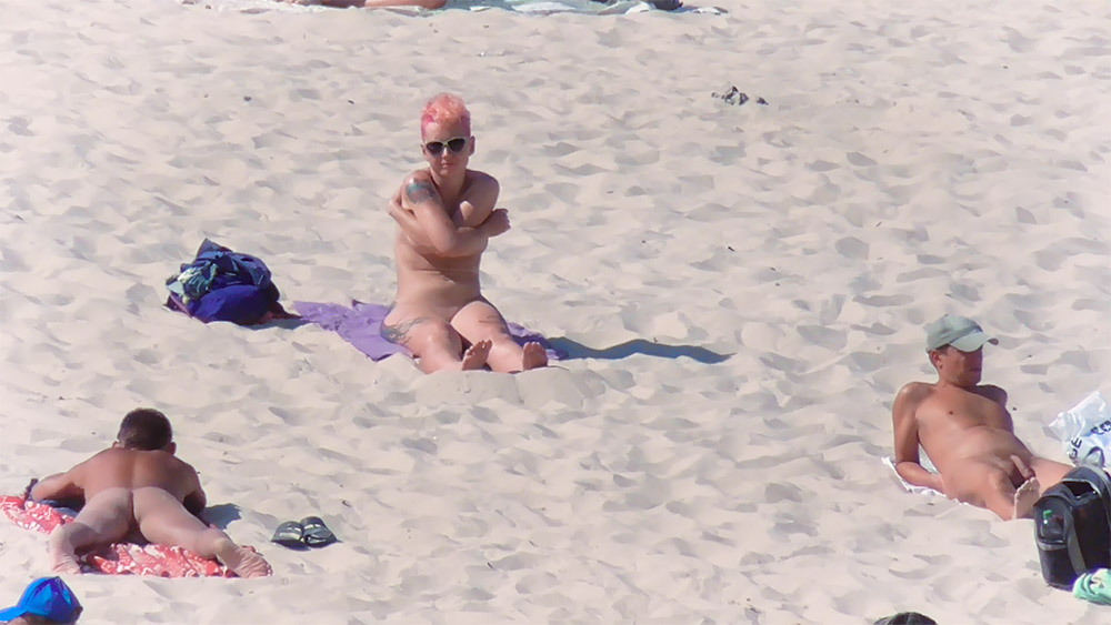 Sandy Nude Beach Spot with a Purple Towel and Tattoos