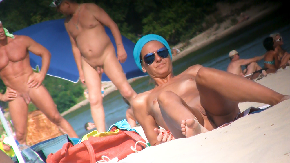 Gorgeous nude beach girls filmed by a voyeur enjoying their day.