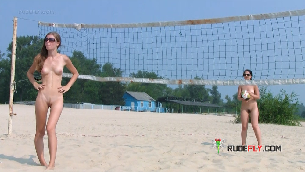 Two Nudists Posing by a Beach Volleyball Net