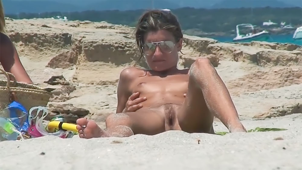 Sitting on the Sand at a Rocky Nude Beach