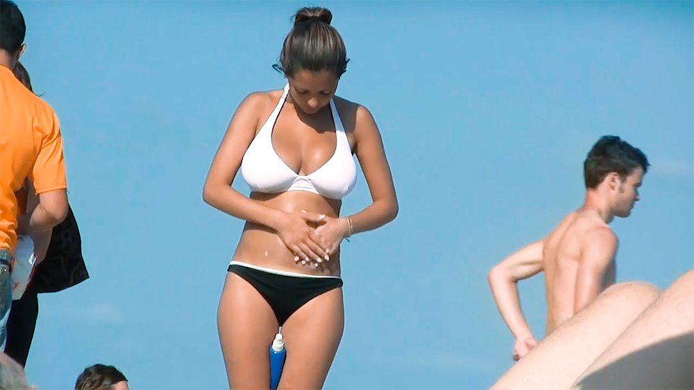 Bright Blue Topless Beach Moment with Hair in a Bun