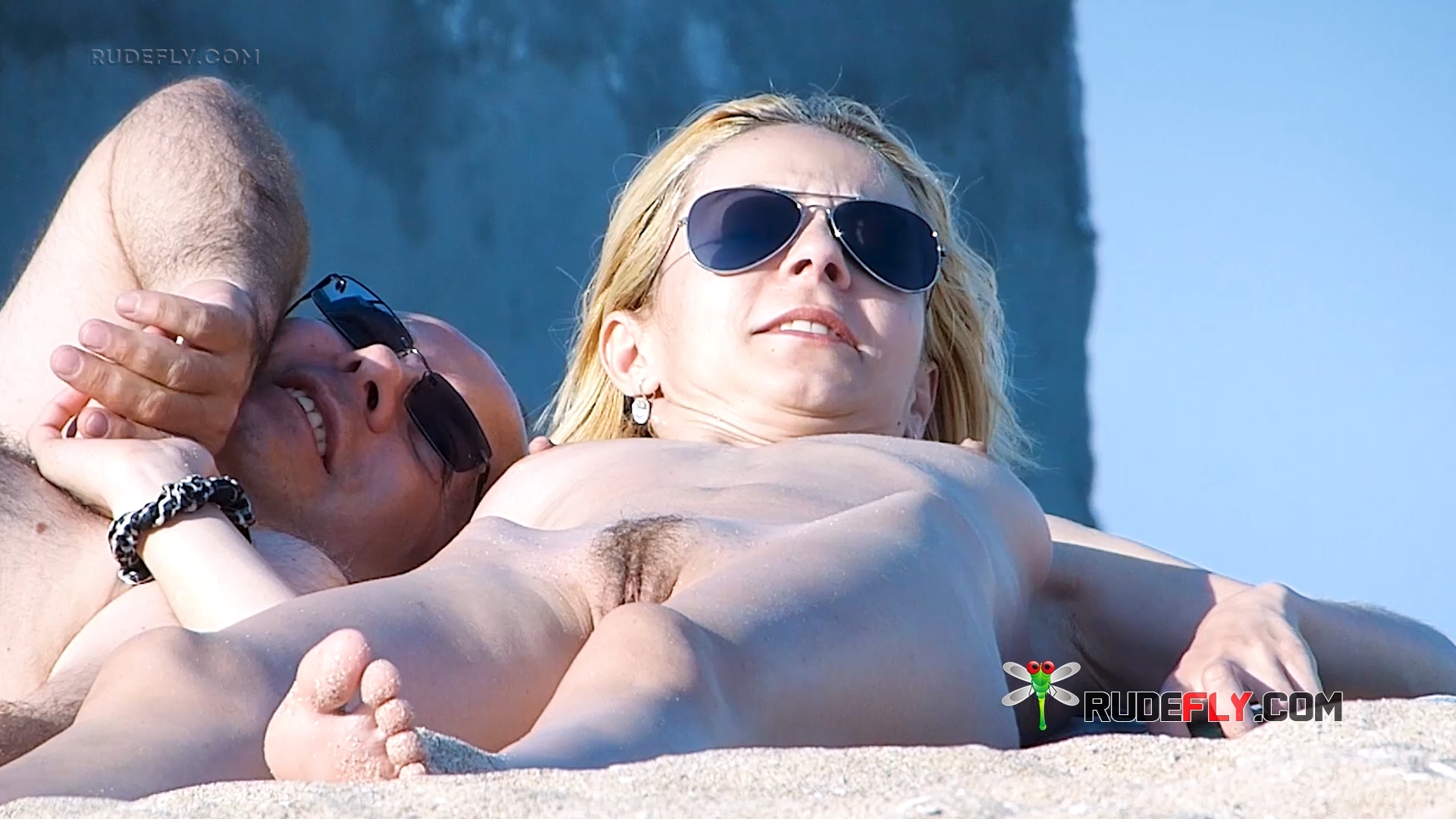 Nude Beach Couple Resting Together on Warm Sand