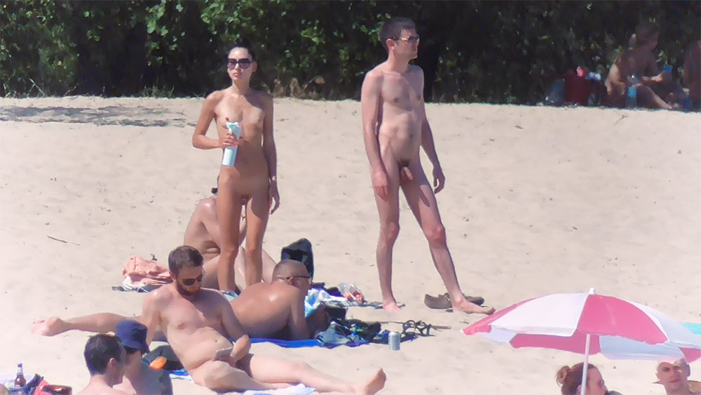 Standing on a Nude Beach Holding a Spray Bottle
