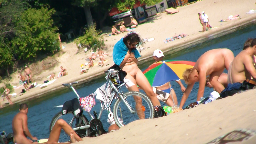 Couple Sitting Together at a Riverside Nude Beach