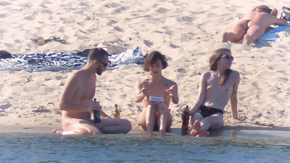 Three Nudists Resting at the Water's Edge