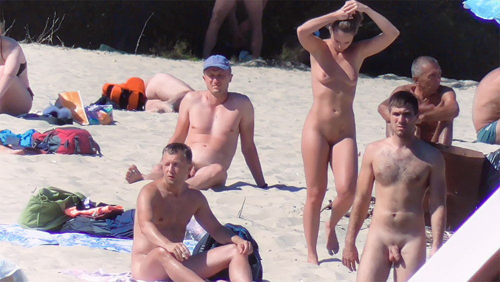 Six Nudists Gathered on the Sand at a Nude Beach