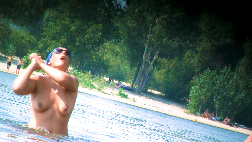 Standing in Shallow Water at a Nudist Beach in a Blue Headscarf