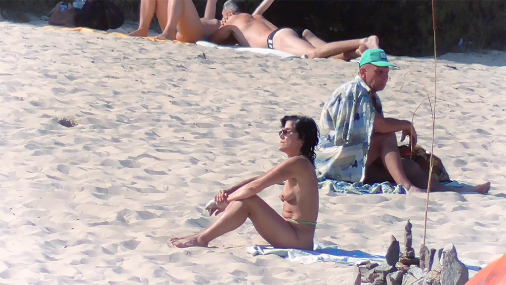 She's getting more and more comfortable on the plage, excited that she's been looked at and cocks are getting hard.