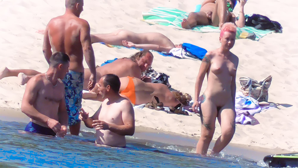 Pink-Haired Nudist Pausing at the Water's Edge