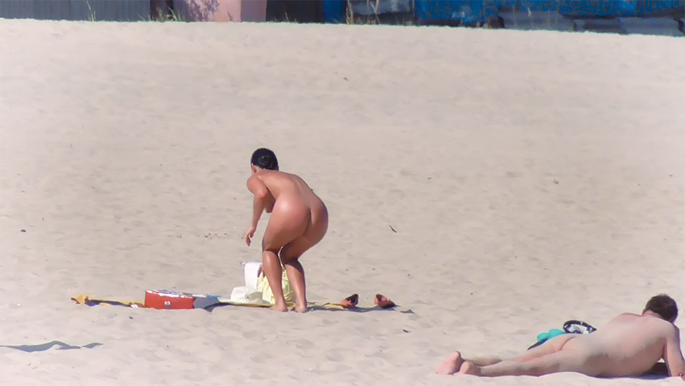 Sandy Nudist Beach Spot with Towel, Sandals and Bucket