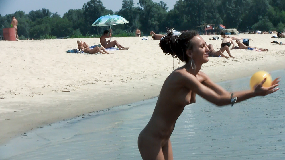 Sunny Shoreline Ball Game with Confident Naturist Women