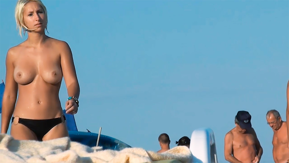 Standing by a Boat in Black Topless Beach Bottoms