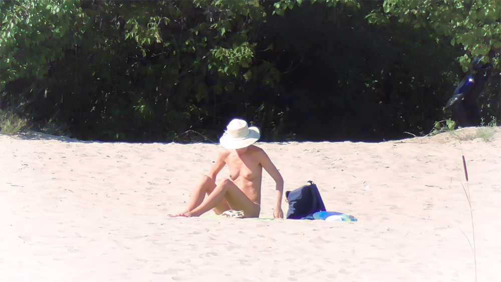 One Nude Beach Sunbather in a Wide-Brimmed White Hat